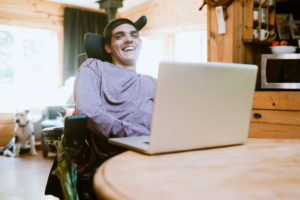Confident Young Man In Wheelchair At Home