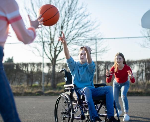 wheelchair user playing basketball